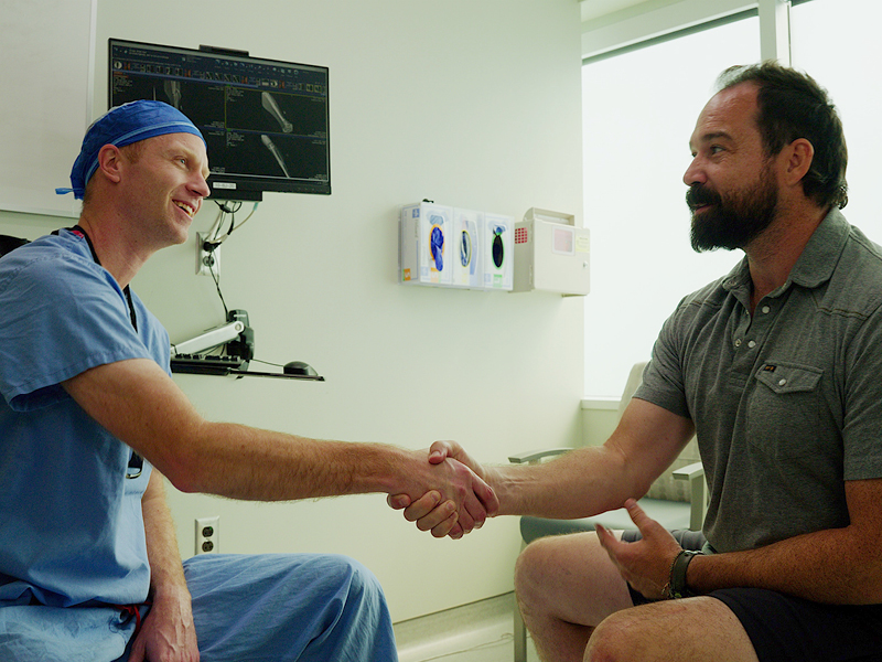 Doctor stretching patients hand